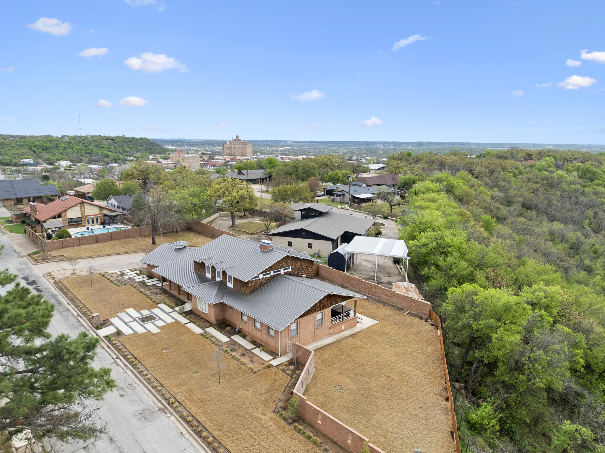Drone shot of a house in Mineral Wells towards the Baker Hotel